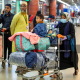 A Bangladeshi national (R) carries luggage on a trolley upon her arrival from Lebanon, at the Hazrat Shahjalal International Airport in Dhaka on October 21, 2024. - The first Bangladeshis airlifted home after fleeing Israeli airstrikes in Lebanon described the constant fear of living in a city rocked by explosions. Late on October 21, the first 54 of some 1,800 Bangladeshis wanting to escape the troubled Mediterranean nation flew back to Dhaka on a government-backed flight. (Photo by Salahuddin Ahmed / AFP)